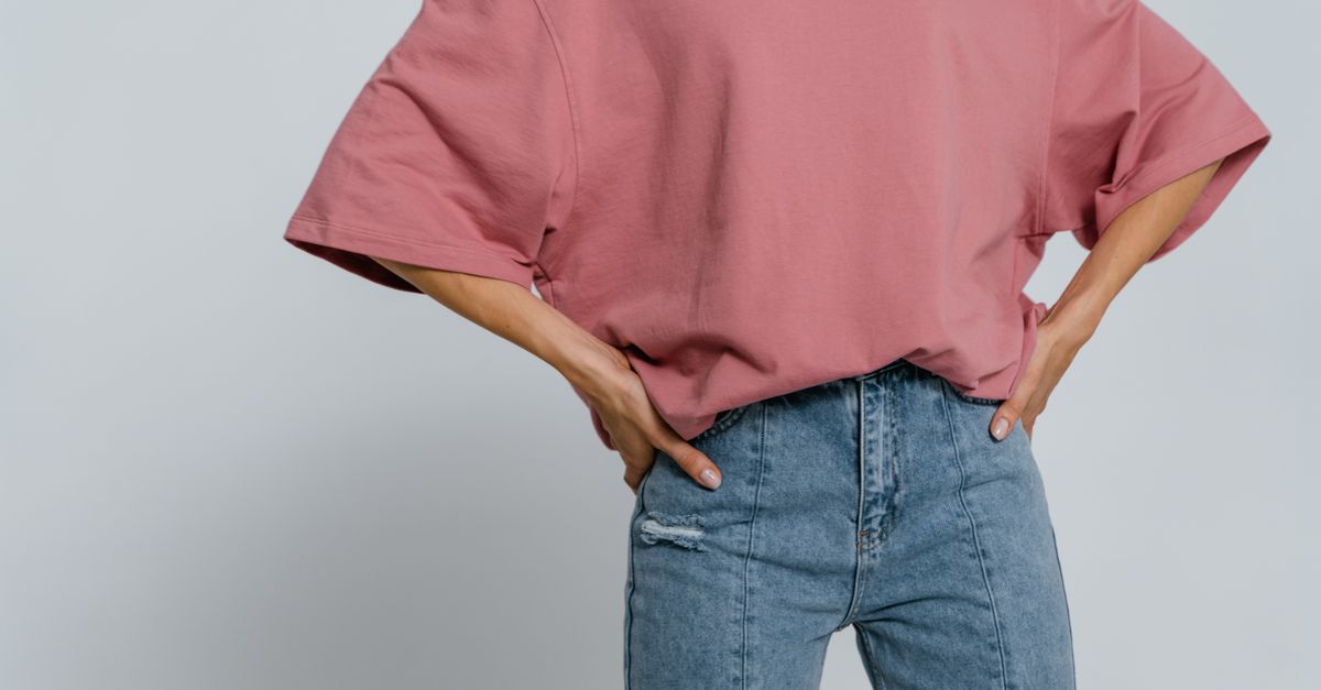 Casual pink t-shirt with jeans in a minimalist studio shot showcasing fashion style.